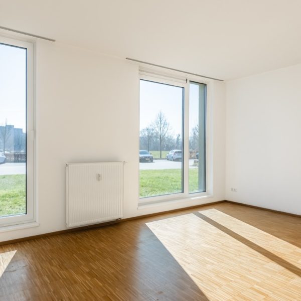 Living room with floor-to-ceiling windows that let plenty of daylight into the flat