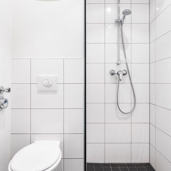 Modern bathroom with floor-level shower and real glass partition